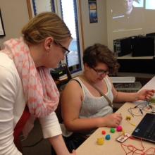 Student and instructor use Play-Doh to create a keypad to play Super Mario Bros.