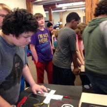 Student uses homemade classic Nintendo controller to play Tetris.